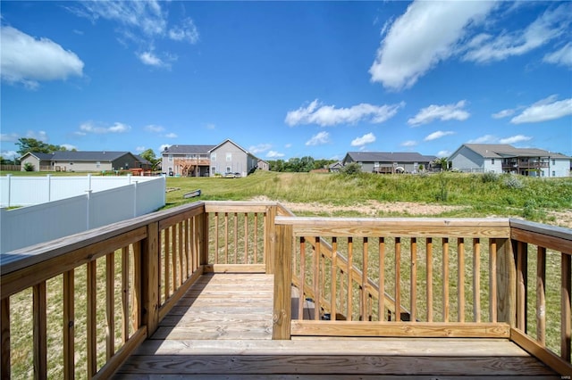 wooden terrace with a lawn