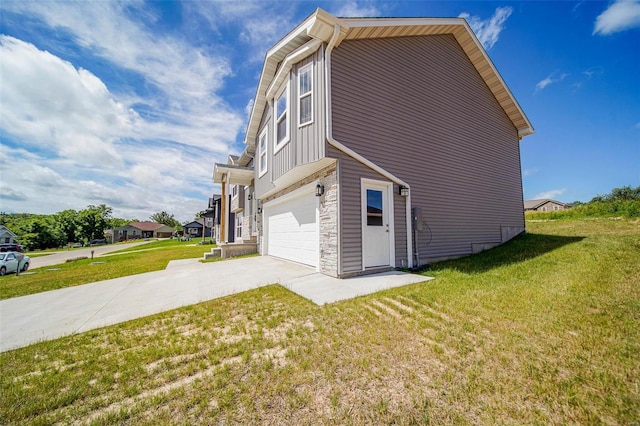 view of side of home featuring a garage and a yard