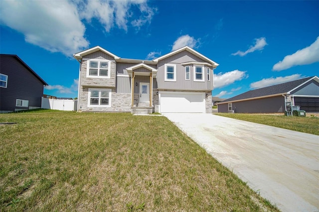 raised ranch featuring a garage and a front yard