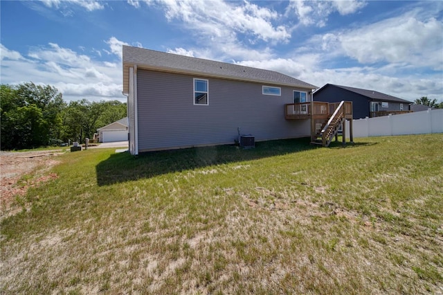 view of home's exterior featuring central AC unit, a yard, and a wooden deck