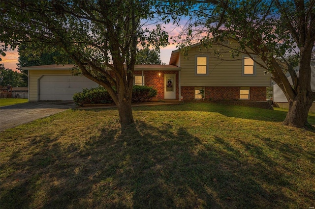 split level home with a yard and a garage