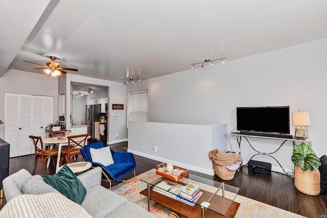 living room with track lighting, hardwood / wood-style floors, and ceiling fan