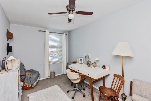 carpeted office space featuring ceiling fan