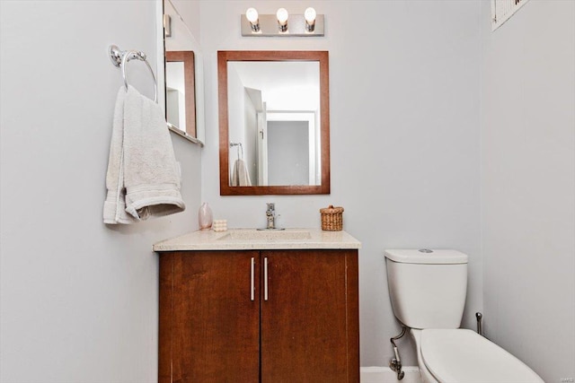 bathroom featuring toilet and large vanity