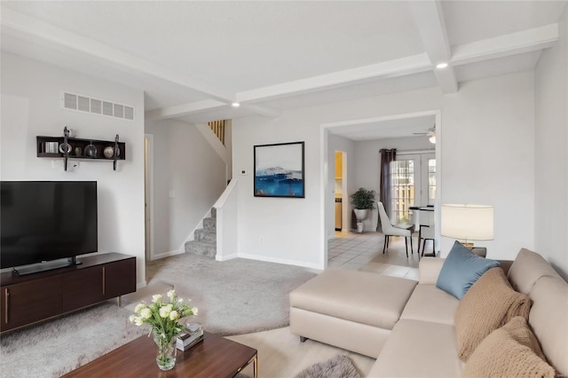 carpeted living room with beamed ceiling and ceiling fan