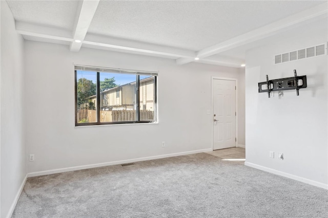 carpeted empty room with beam ceiling and coffered ceiling