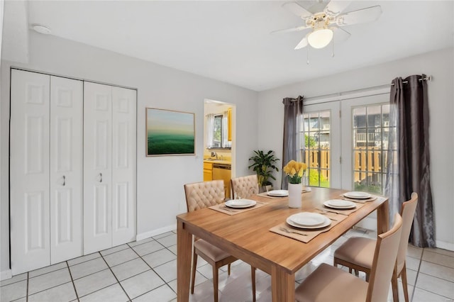 dining space with ceiling fan and light tile patterned floors