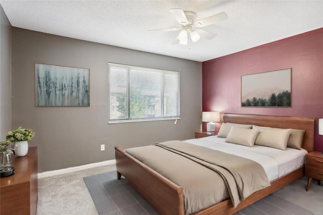 bedroom with light carpet, a textured ceiling, and ceiling fan