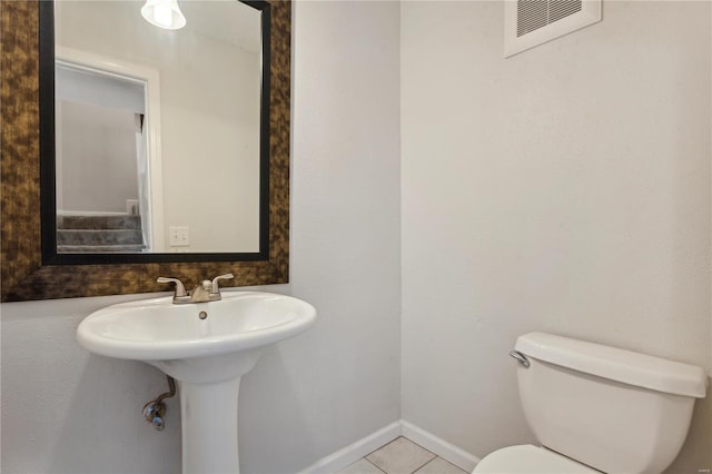 bathroom featuring toilet and tile patterned floors