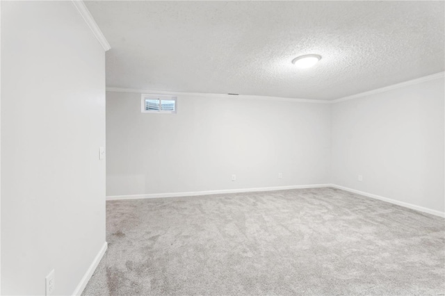 basement featuring carpet, a textured ceiling, and ornamental molding