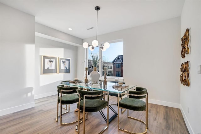 dining space featuring wood-type flooring