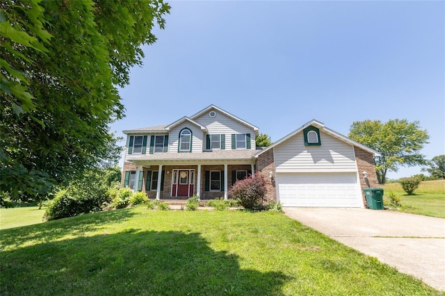 view of front of house featuring a front yard, a garage, and covered porch