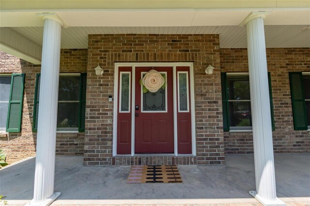 view of exterior entry featuring a porch