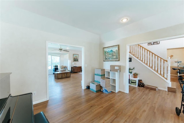 living room with ceiling fan and wood-type flooring