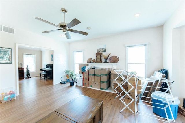 living room featuring ceiling fan and hardwood / wood-style flooring