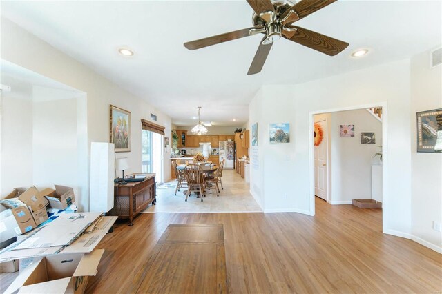 unfurnished living room featuring light hardwood / wood-style floors and ceiling fan