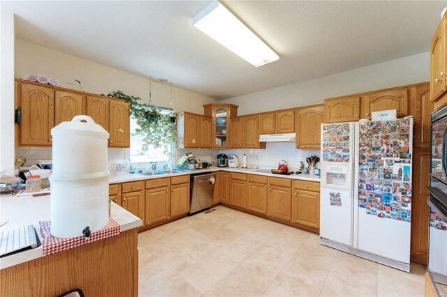 kitchen with white fridge with ice dispenser, backsplash, dishwasher, and light tile floors