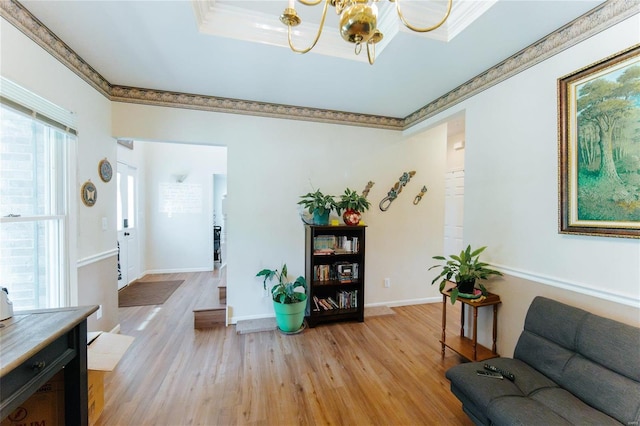 living room with a chandelier, plenty of natural light, and light wood-type flooring