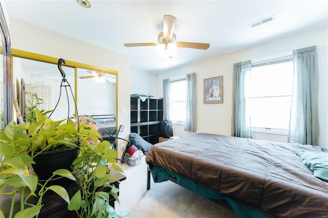 carpeted bedroom with a closet and ceiling fan