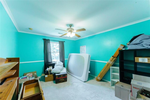 carpeted home office with ornamental molding and ceiling fan