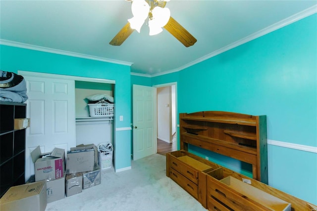 carpeted bedroom featuring ceiling fan and crown molding