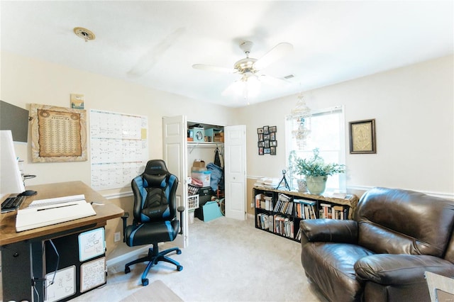 carpeted home office featuring ceiling fan