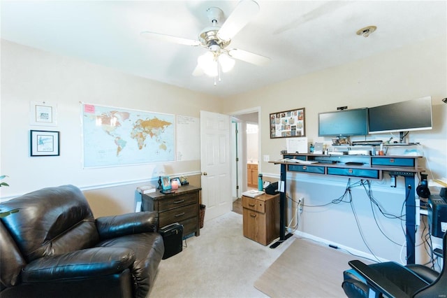 carpeted home office with ceiling fan