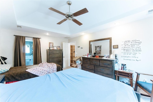 bedroom featuring ceiling fan and a raised ceiling