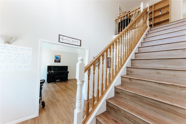 stairs featuring light wood-type flooring