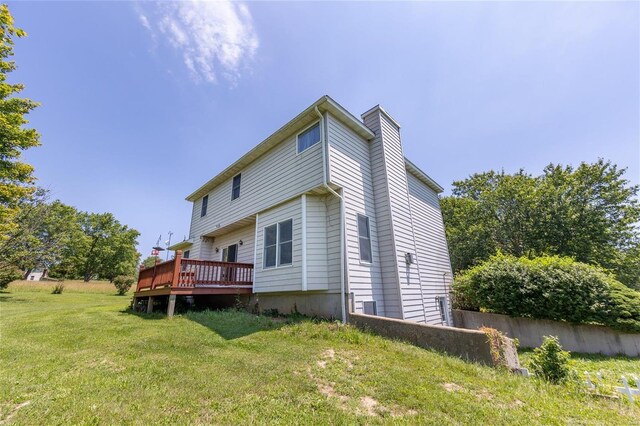 back of house with a yard and a deck