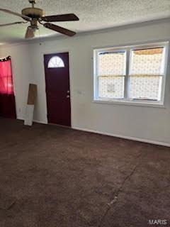 entryway featuring a wealth of natural light, ceiling fan, and a textured ceiling