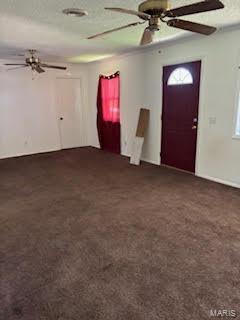 carpeted foyer with ceiling fan