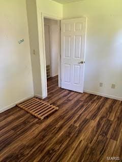 unfurnished bedroom with dark wood-type flooring