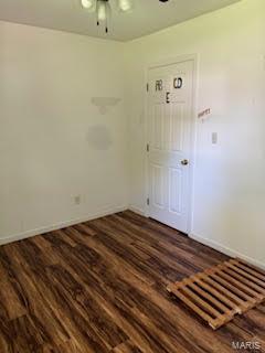 spare room featuring dark hardwood / wood-style floors and ceiling fan