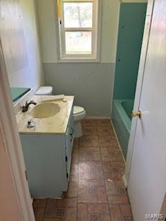 full bathroom featuring washtub / shower combination, toilet, and vanity