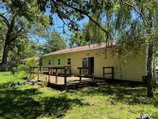 back of house with a lawn and a wooden deck