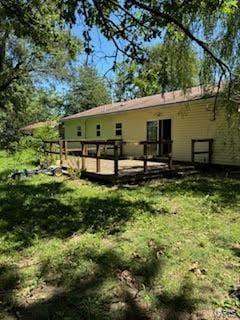 rear view of house featuring a deck