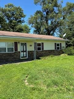 ranch-style home with a front lawn