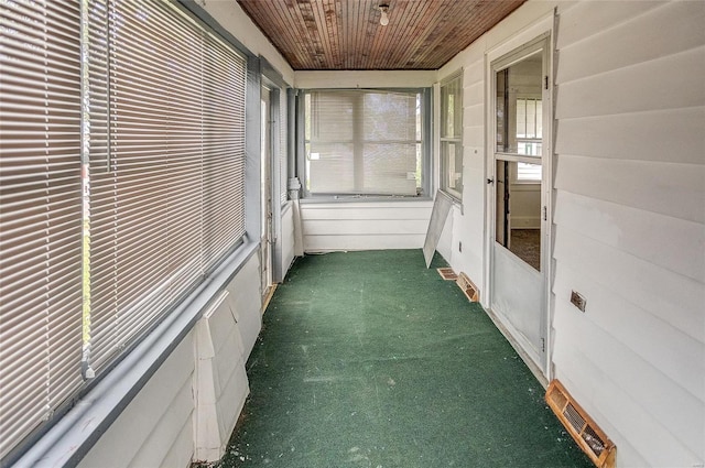 unfurnished sunroom with wooden ceiling