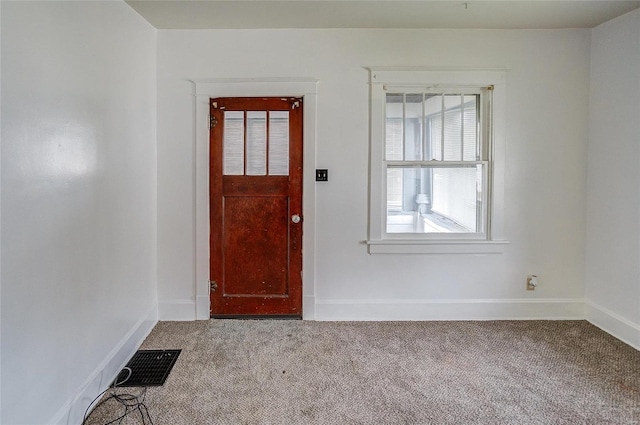 view of carpeted foyer entrance