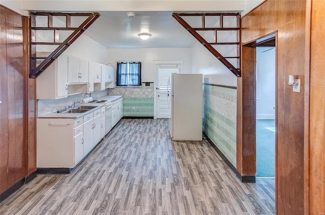 kitchen featuring light hardwood / wood-style flooring, white cabinets, white appliances, and sink