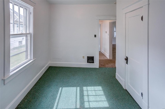 unfurnished room with carpet flooring and a wealth of natural light