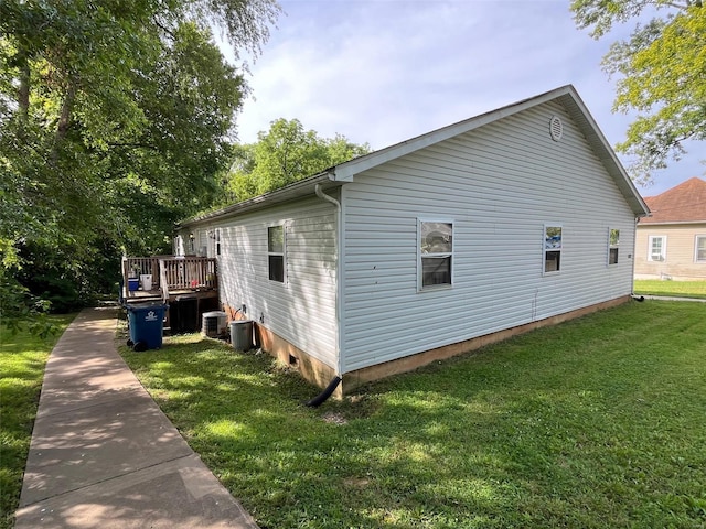 view of side of home with a lawn, central AC unit, and a deck