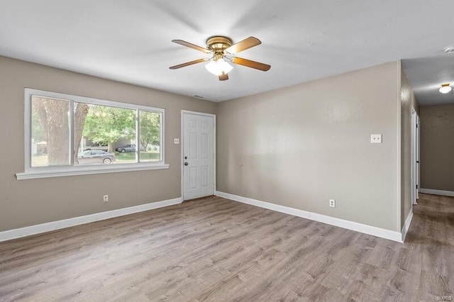 spare room featuring light wood-type flooring and ceiling fan