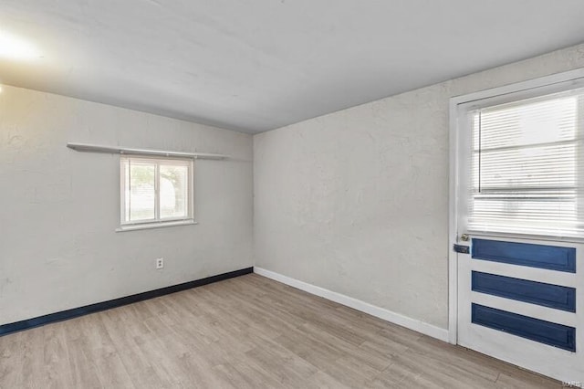 spare room featuring light hardwood / wood-style floors