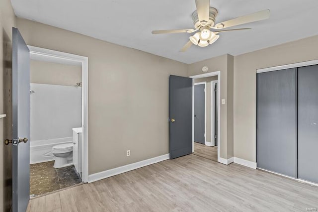 unfurnished bedroom featuring a closet, ceiling fan, light hardwood / wood-style floors, and ensuite bathroom