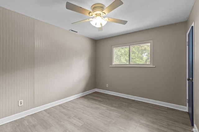 spare room with hardwood / wood-style floors and ceiling fan