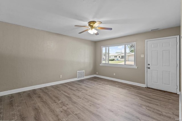 empty room featuring light hardwood / wood-style flooring and ceiling fan