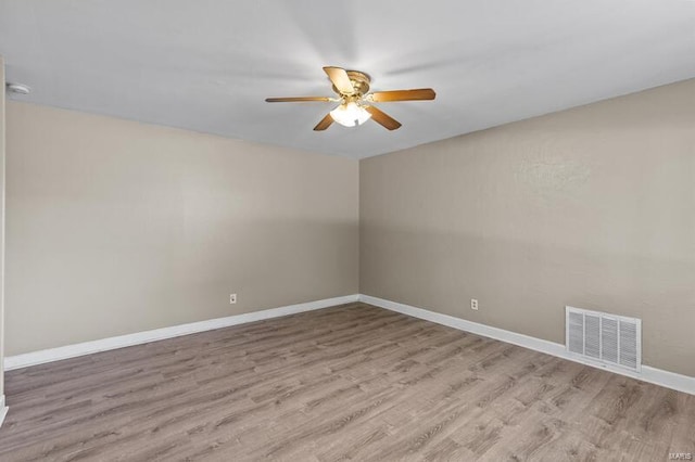 empty room with ceiling fan and light hardwood / wood-style floors