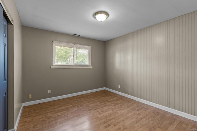 spare room with hardwood / wood-style flooring